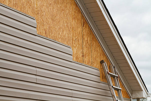 Professional Siding Contractor technician working in Newton Center, MA
